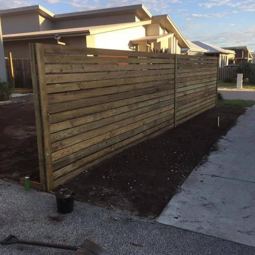 Timber fencing with retaining wall